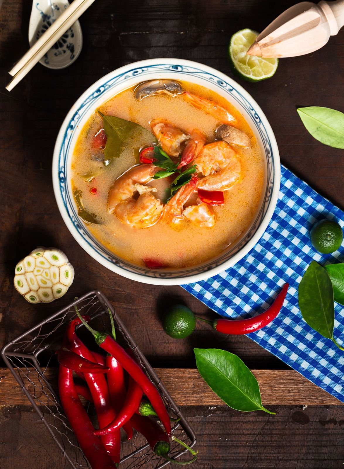 A steaming bowl of curry laksa with prawns, chillies and lime